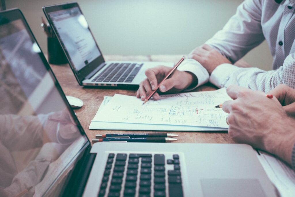 Two people reviewing business performance figures at a desk